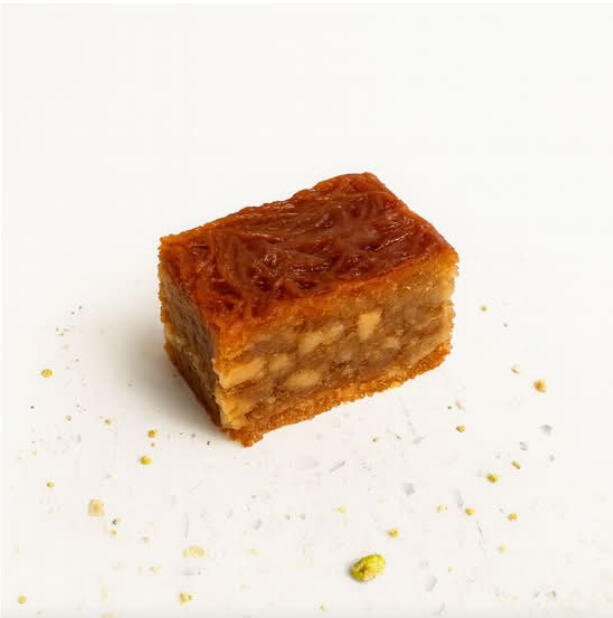 Balaurieh (Red) W/ Walnut $46.00 Shredded phyllo pastry layered with walnut filling, tinted red and finished with light syrup for a classic baklava bite.