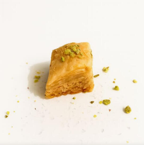 Diamond W/ Cashews $42.00 Diamond-shaped baklawa with flaky phyllo layers filled with cashews, finished with syrup.