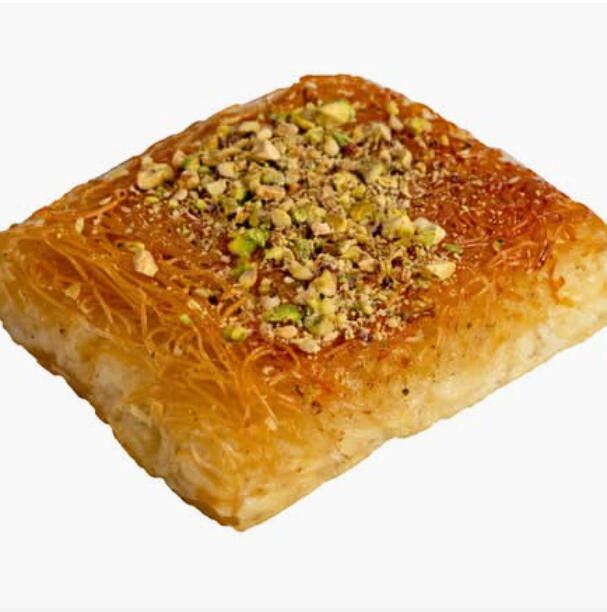 Knefeh Nabulsieh W/ Cheese $42.00 Nabulsieh knefeh with a melty cheese centre, crisp shredded phyllo crust, soaked in syrup and finished with crushed pistachios.