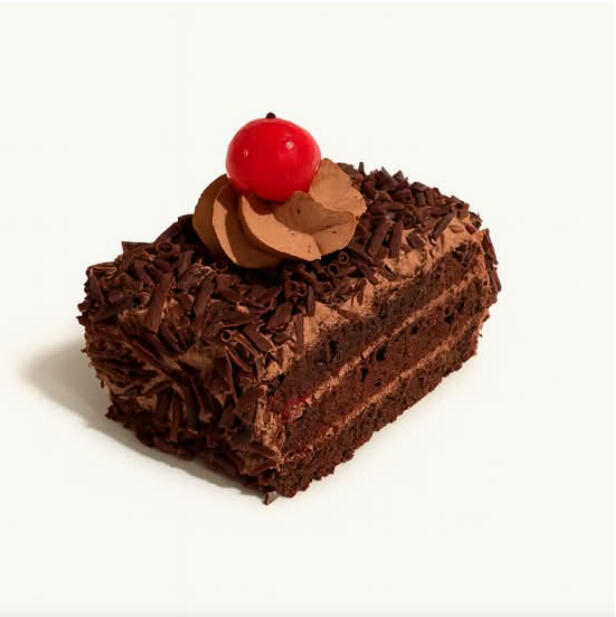 Black Forest Slice $7.49 Layered chocolate sponge and chocolate cream, coated in chocolate shavings and finished with a cherry on top.