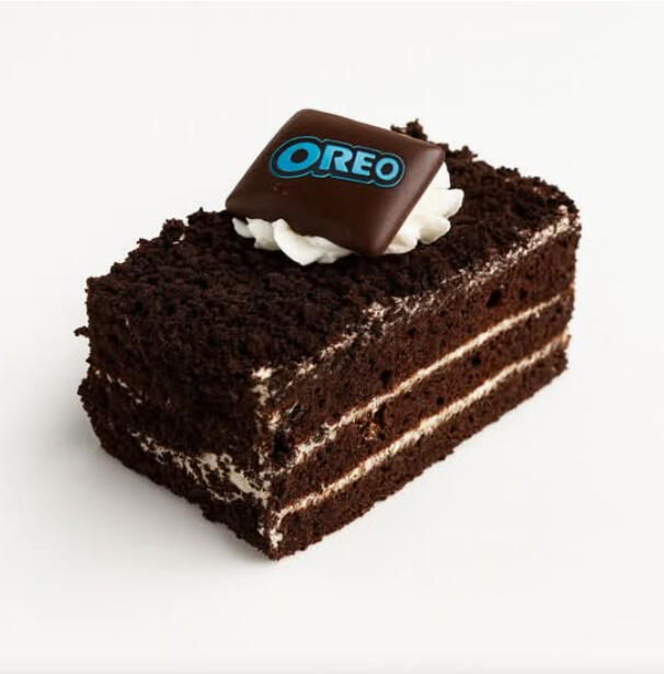 Oreo Cake Slice $7.49 Chocolate cake with cream layers, coated in chocolate crumbs and topped with a dollop of cream and an OREO chocolate piece.