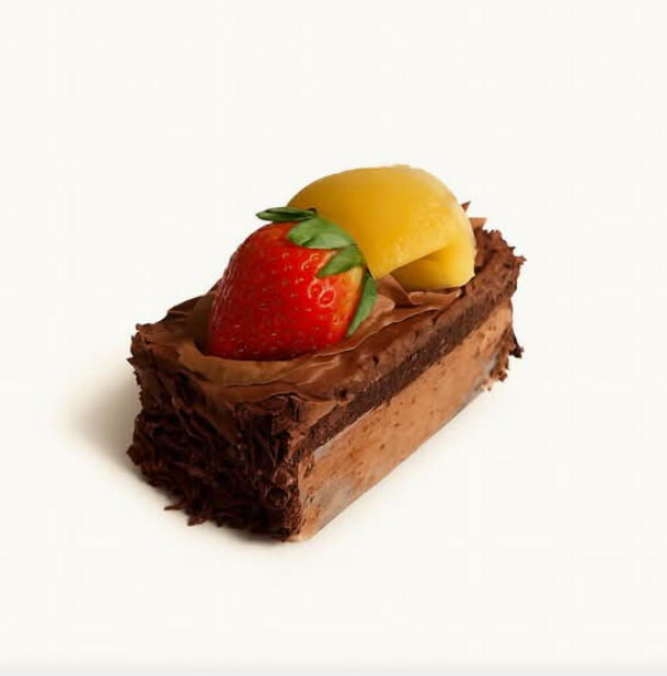 Black Forest w/ Fruits Cake Slice $7.49 A slice of layered chocolate cake with chocolate cream and shavings, finished with strawberry and peach on top.
