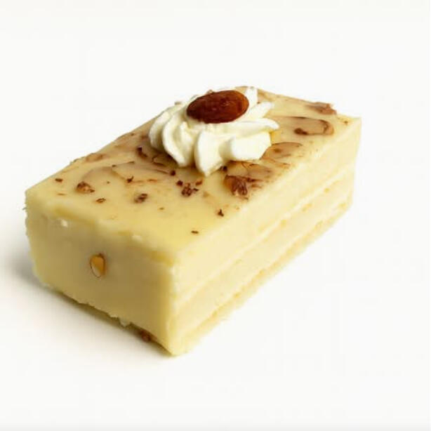 Vanilla Almond Cake Slice $7.49 Vanilla cake slice with light layers, topped with sliced almonds and a small cream rosette for a nutty finish.